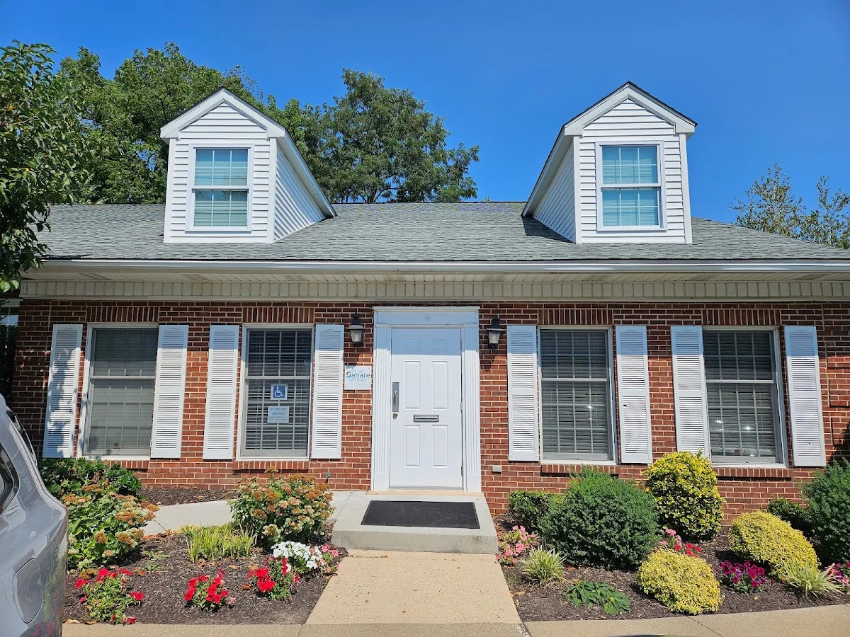 Welcoming brick exterior with landscaped garden at Sanare, an intensive outpatient program in Delaware.