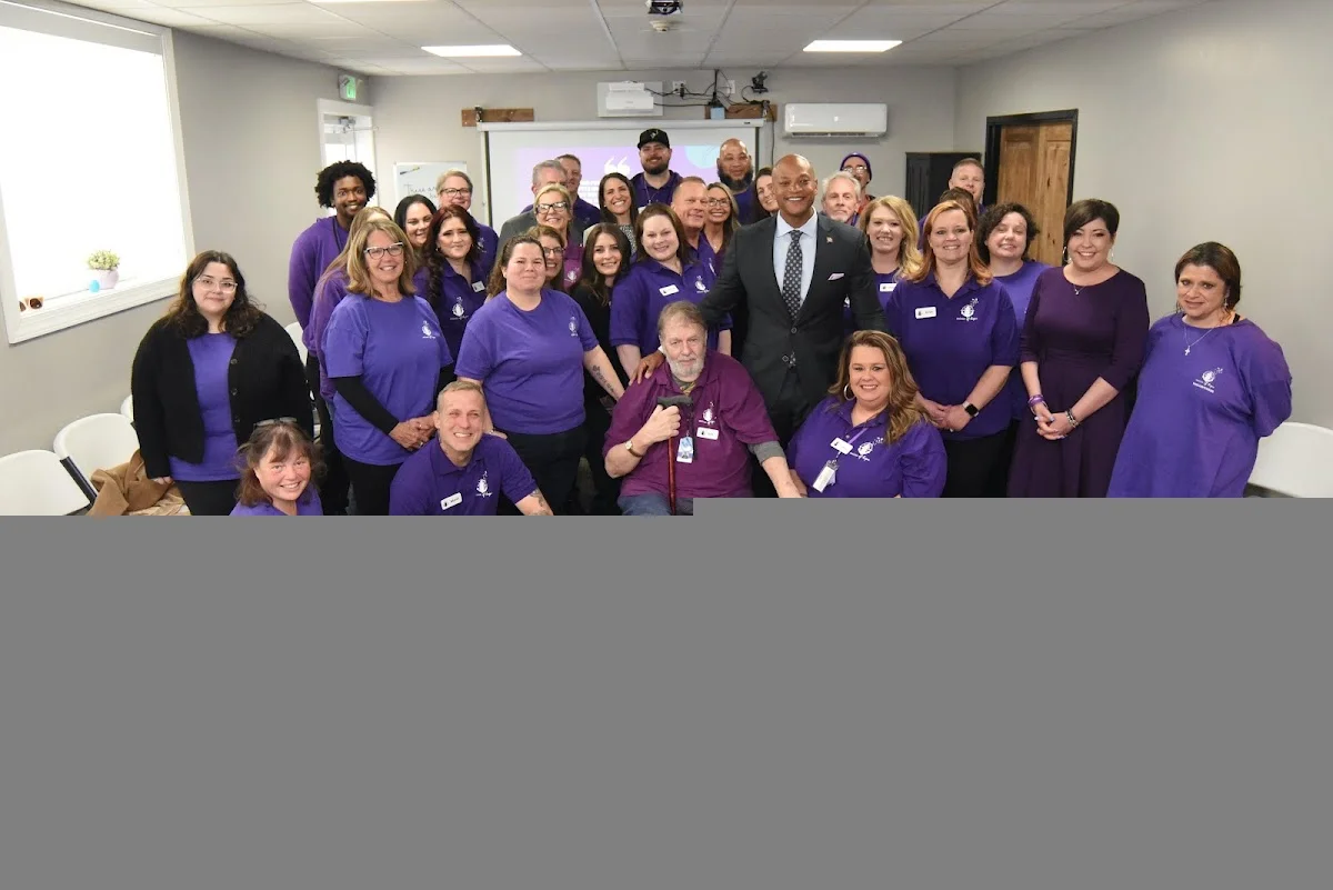 Group of smiling staff and residents at Voices of Hope, Inc., a sober living home in Delaware.