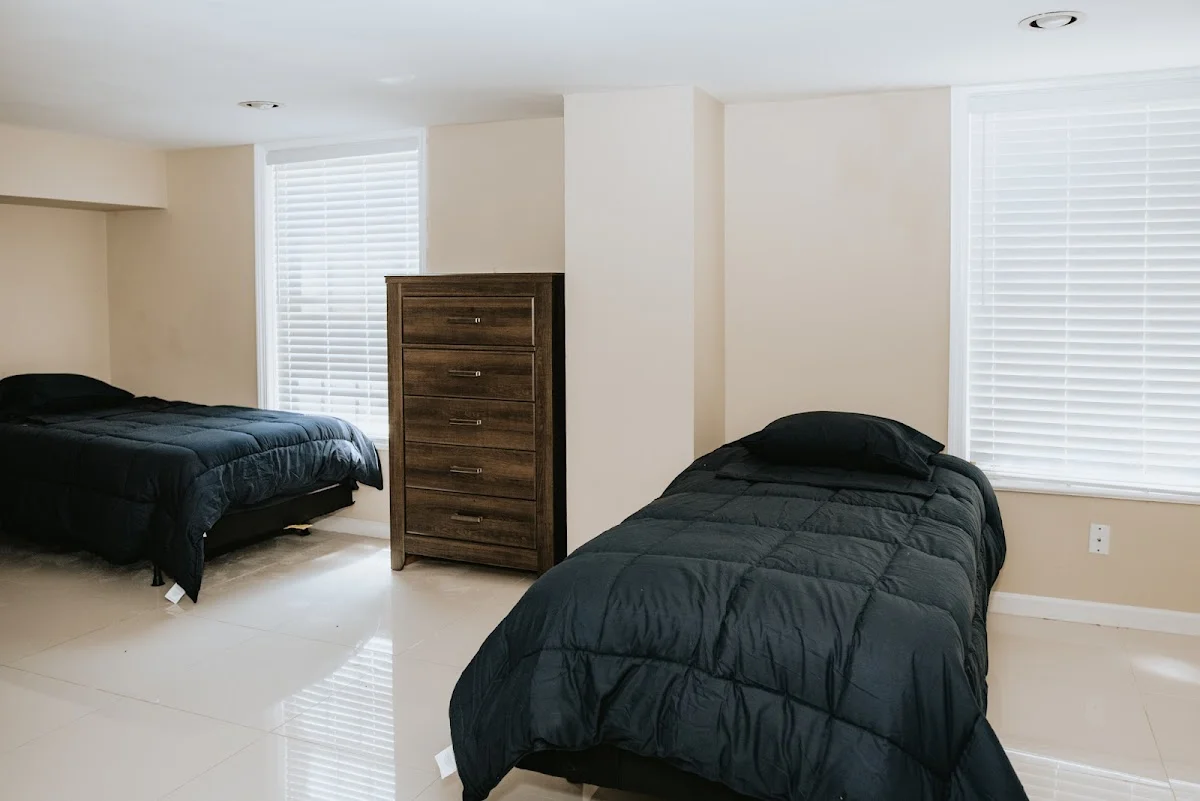 Cozy bedroom with two beds at South Jersey Recovery Residences sober living home in Delaware.