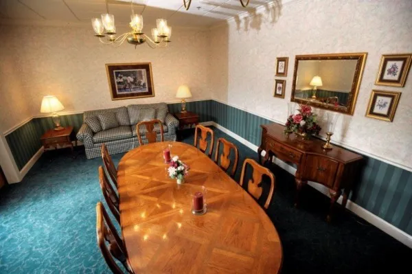 Elegant dining area with chandelier at Cadia Rehabilitation Capitol, a sober living home in Delaware.